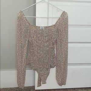 Pinkish cream bodysuit with floral designs